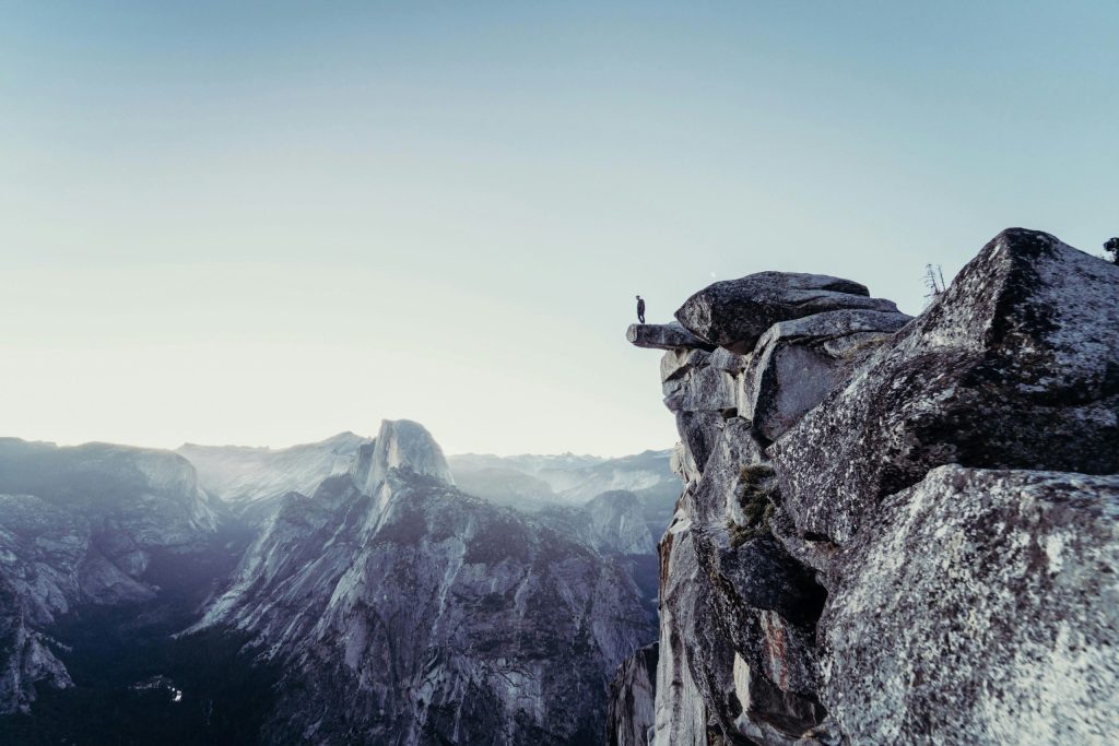 man on edge of mountain top.