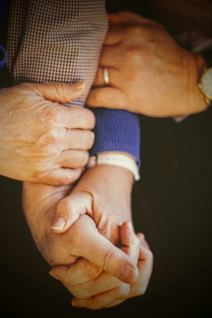 different sets of hands holding one another.